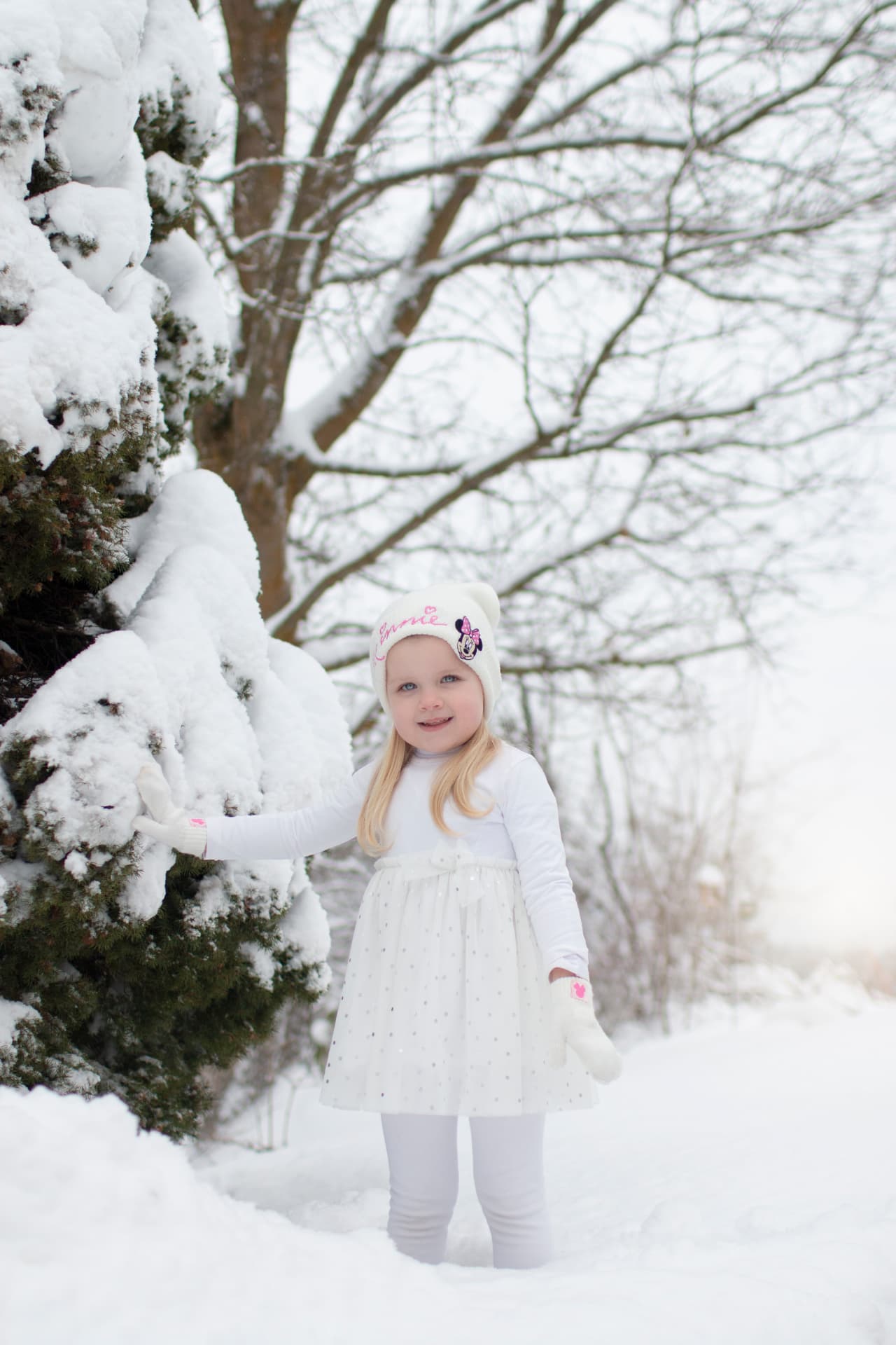 Little girl playing in fresh snow