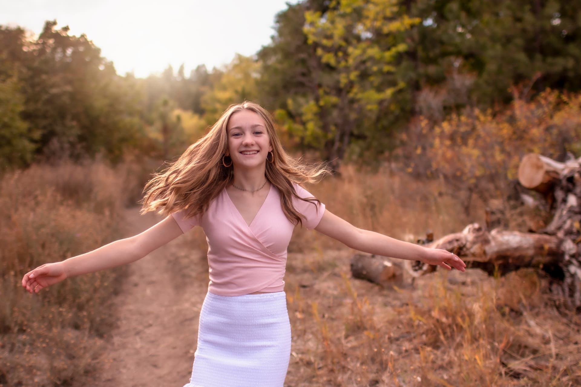 Girl spinning with joy in golden autumn light